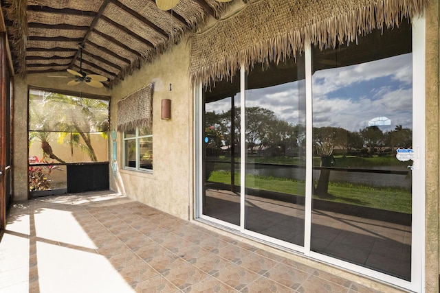 unfurnished sunroom featuring a water view