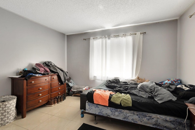 bedroom with light tile patterned flooring and a textured ceiling