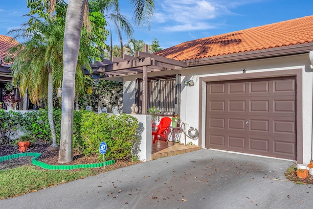 mediterranean / spanish house with a garage, a tiled roof, driveway, a pergola, and stucco siding