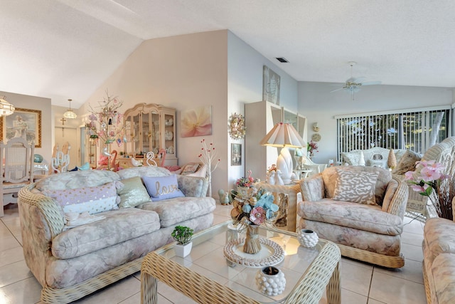 living room featuring light tile patterned floors, visible vents, a ceiling fan, vaulted ceiling, and a textured ceiling