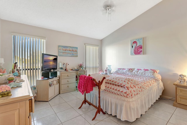 bedroom with vaulted ceiling and light tile patterned flooring