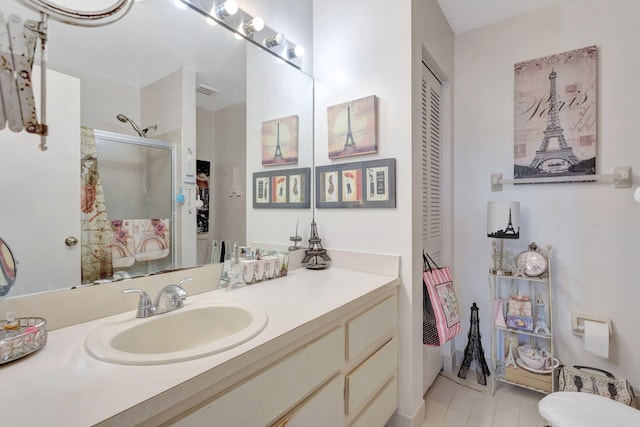 full bath with tile patterned flooring, a closet, a shower stall, and vanity