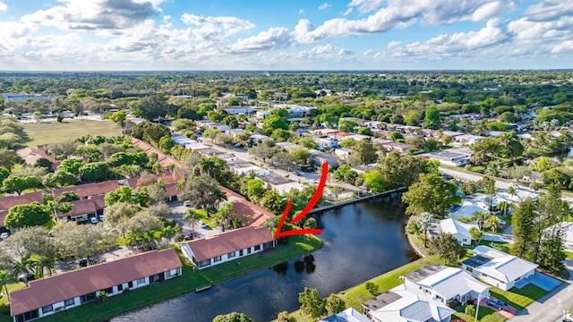 drone / aerial view with a water view and a residential view