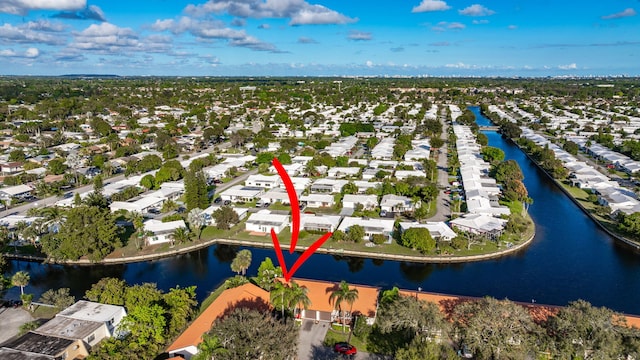 drone / aerial view with a water view and a residential view