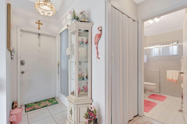 bathroom with toilet and tile patterned floors