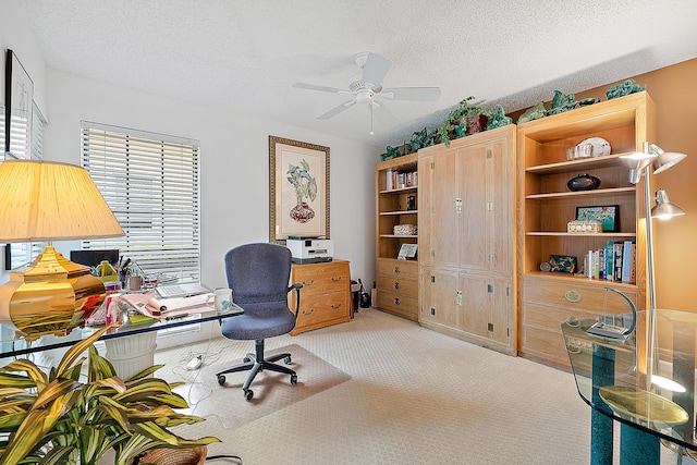 office with carpet, ceiling fan, and a textured ceiling