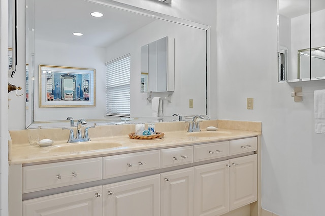 full bathroom featuring recessed lighting, a sink, and double vanity