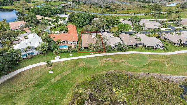 bird's eye view featuring a water view, view of golf course, and a residential view