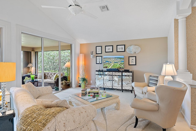 carpeted living area featuring visible vents, lofted ceiling, decorative columns, and a ceiling fan