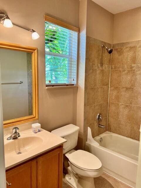 bathroom featuring toilet, tile patterned floors, vanity, and shower / bathtub combination