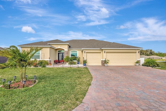 view of front of house with a front yard, decorative driveway, an attached garage, and stucco siding