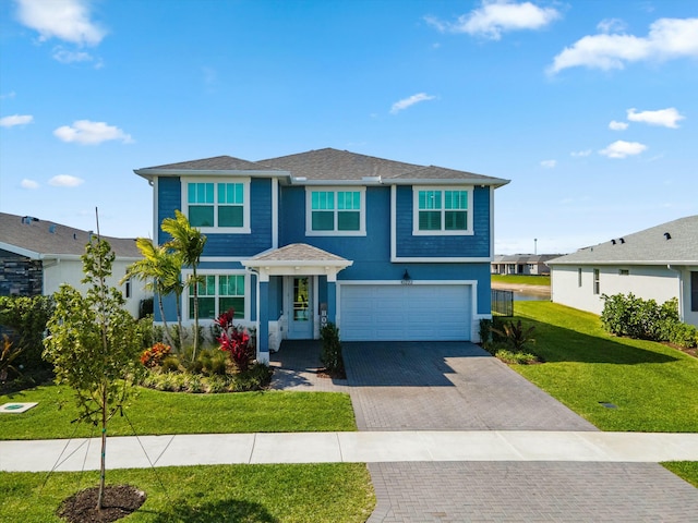 view of front of home with a garage, a front lawn, decorative driveway, and stucco siding