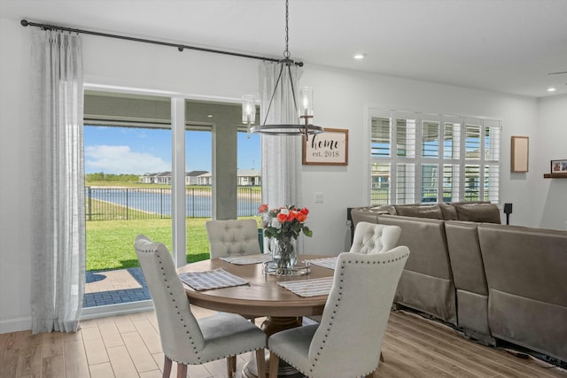 dining space featuring an inviting chandelier, wood finished floors, and recessed lighting