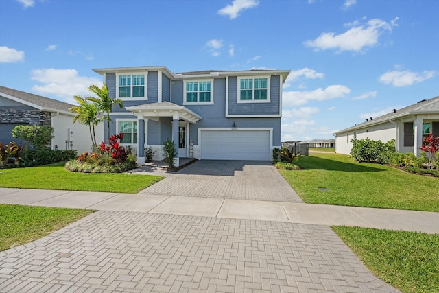 view of front of home featuring a garage, decorative driveway, a front yard, and stucco siding