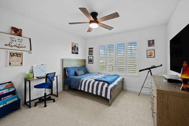 carpeted bedroom with a ceiling fan and baseboards