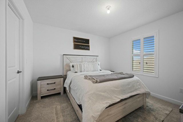 bedroom with carpet floors and baseboards