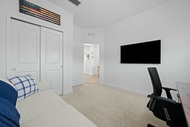 carpeted office space with baseboards and visible vents