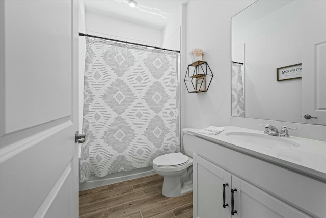 bathroom featuring vanity, toilet, and wood finished floors