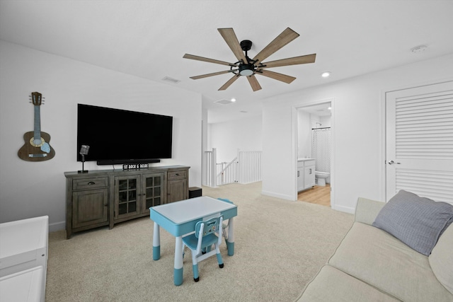 living room featuring light carpet, visible vents, baseboards, ceiling fan, and recessed lighting