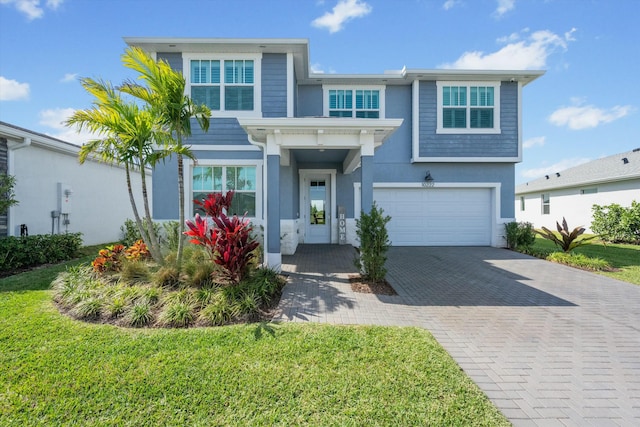 view of front of property with an attached garage, a front yard, decorative driveway, and stucco siding