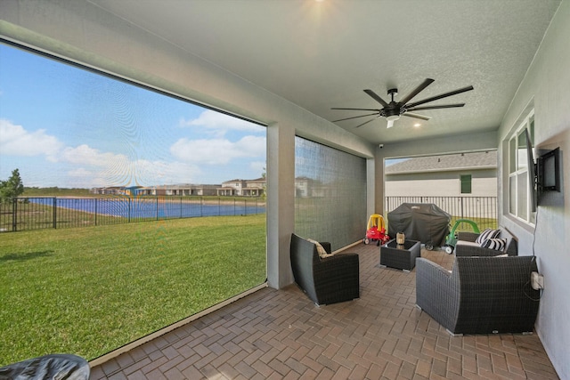 sunroom with a wealth of natural light and ceiling fan