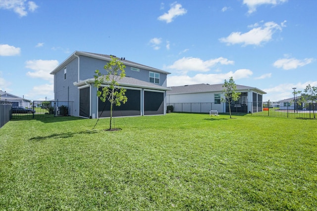 back of property featuring a fenced backyard, a lawn, and stucco siding