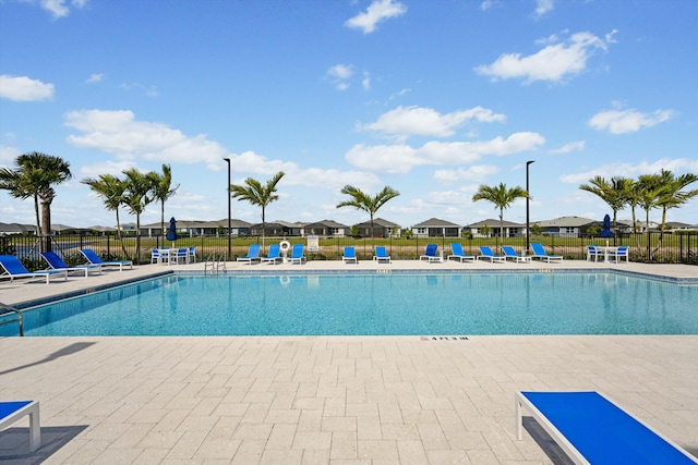 pool featuring a patio and fence