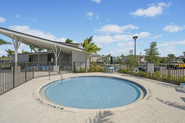 pool with a residential view and fence