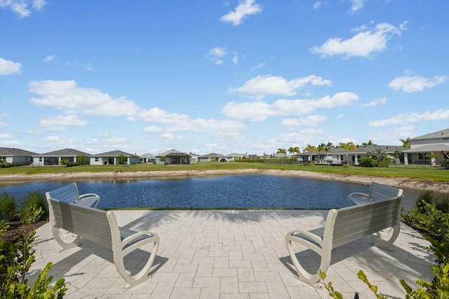 view of swimming pool with a residential view and a water view