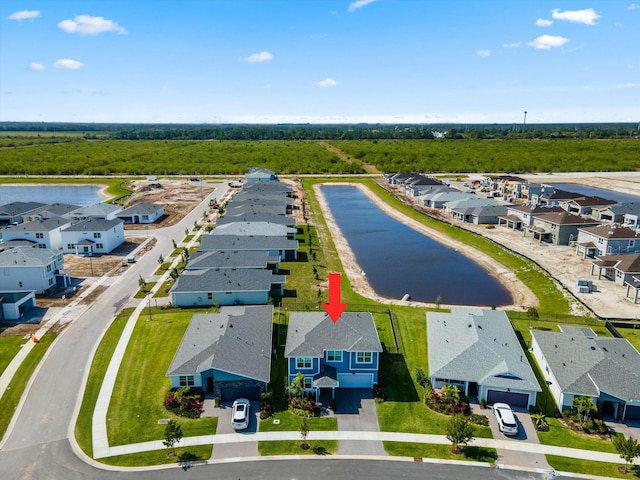 drone / aerial view featuring a water view and a residential view