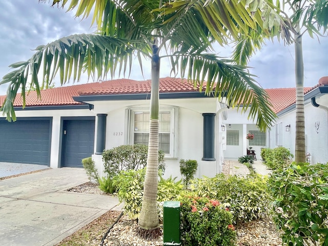 8232 Via Di Veneto, Boca Raton, FL 33496 - mediterranean / spanish-style home featuring stucco siding, an attached garage, driveway, and a tiled roof