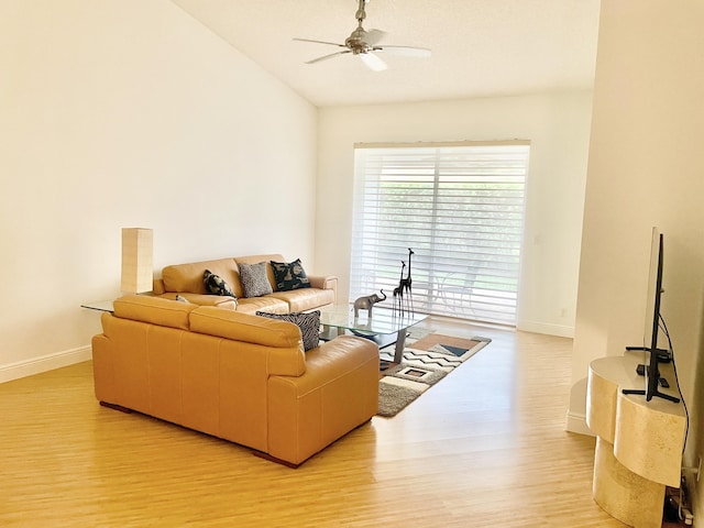 living area featuring vaulted ceiling, a ceiling fan, baseboards, and light wood finished floors