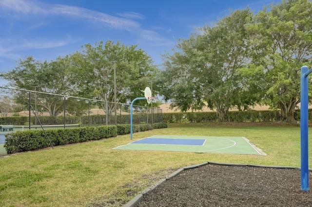 view of sport court featuring a yard, community basketball court, and fence