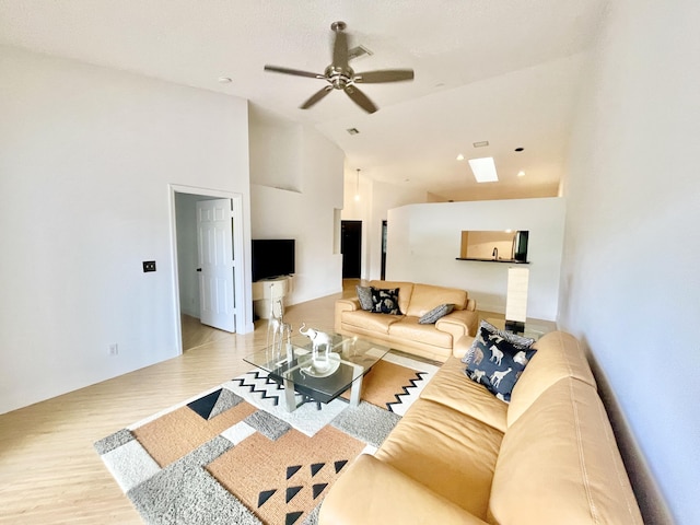 living room with visible vents, high vaulted ceiling, wood finished floors, and a ceiling fan