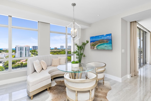 interior space with baseboards, a notable chandelier, and a healthy amount of sunlight