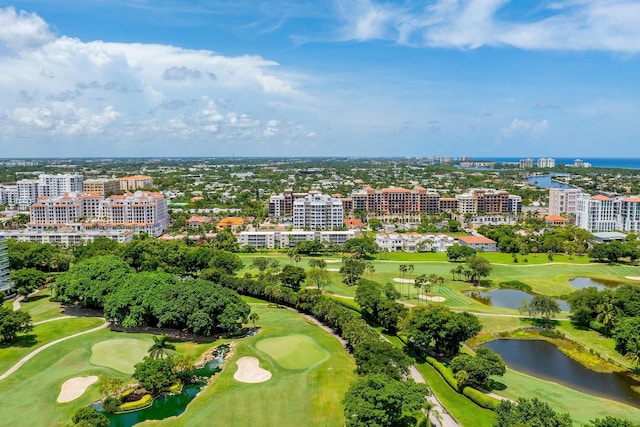 aerial view with view of golf course, a water view, and a city view