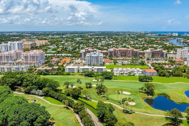 drone / aerial view with a view of city, golf course view, and a water view