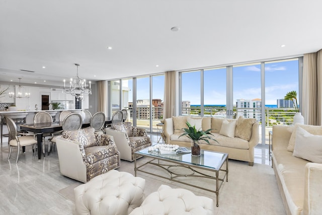 living area featuring a view of city, floor to ceiling windows, a notable chandelier, and recessed lighting