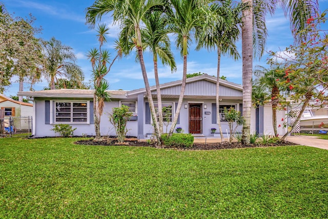 view of front of home featuring driveway, a front lawn, and stucco siding