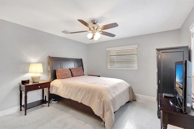 bedroom with light carpet, ceiling fan, and baseboards