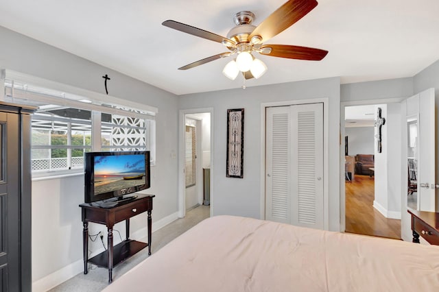 bedroom featuring ceiling fan, baseboards, and a closet