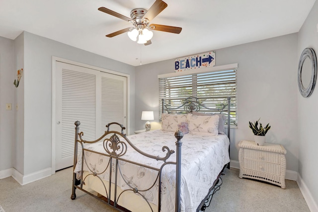 bedroom with a closet, ceiling fan, and baseboards