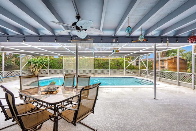 outdoor pool with a lanai, a patio area, and ceiling fan