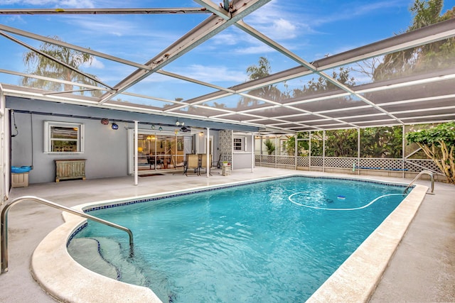 outdoor pool featuring a lanai, fence, and a patio