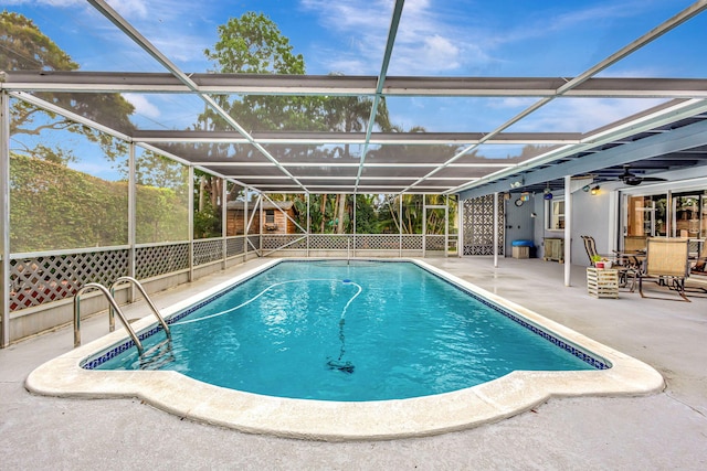 outdoor pool featuring ceiling fan, glass enclosure, a patio, and fence