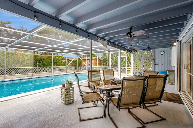 pool featuring outdoor dining space, a lanai, and a patio area