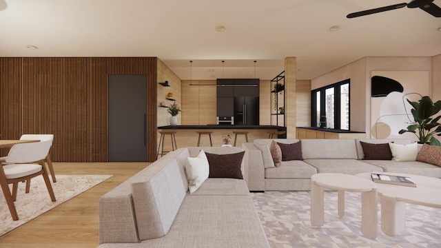 living room featuring light wood finished floors and ceiling fan