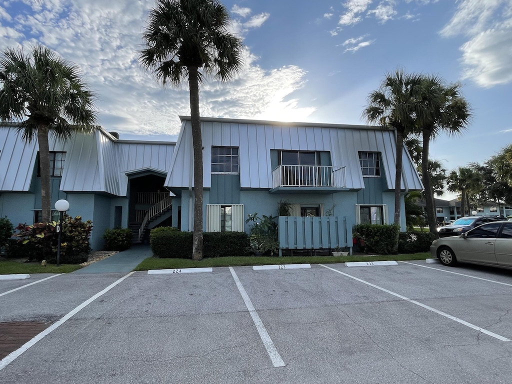 950 S Kanner Hwy Unit D-22, Stuart, FL 34994 - view of building exterior featuring uncovered parking and stairs