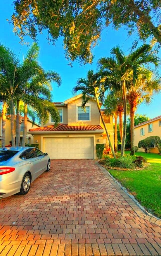 view of front of home featuring a garage, decorative driveway, and stucco siding