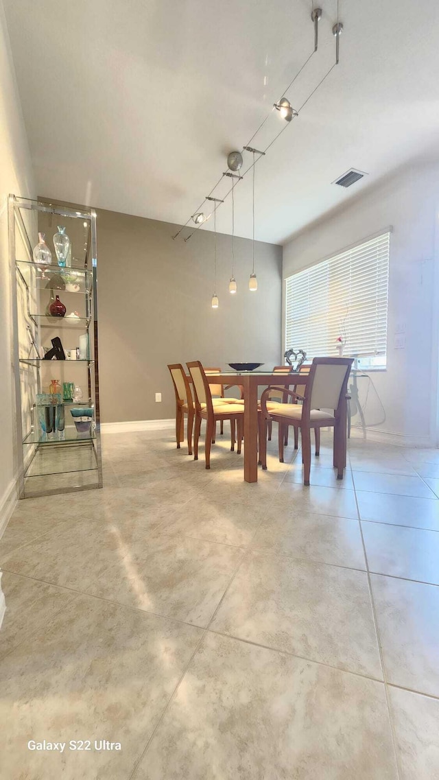 dining room with visible vents and baseboards